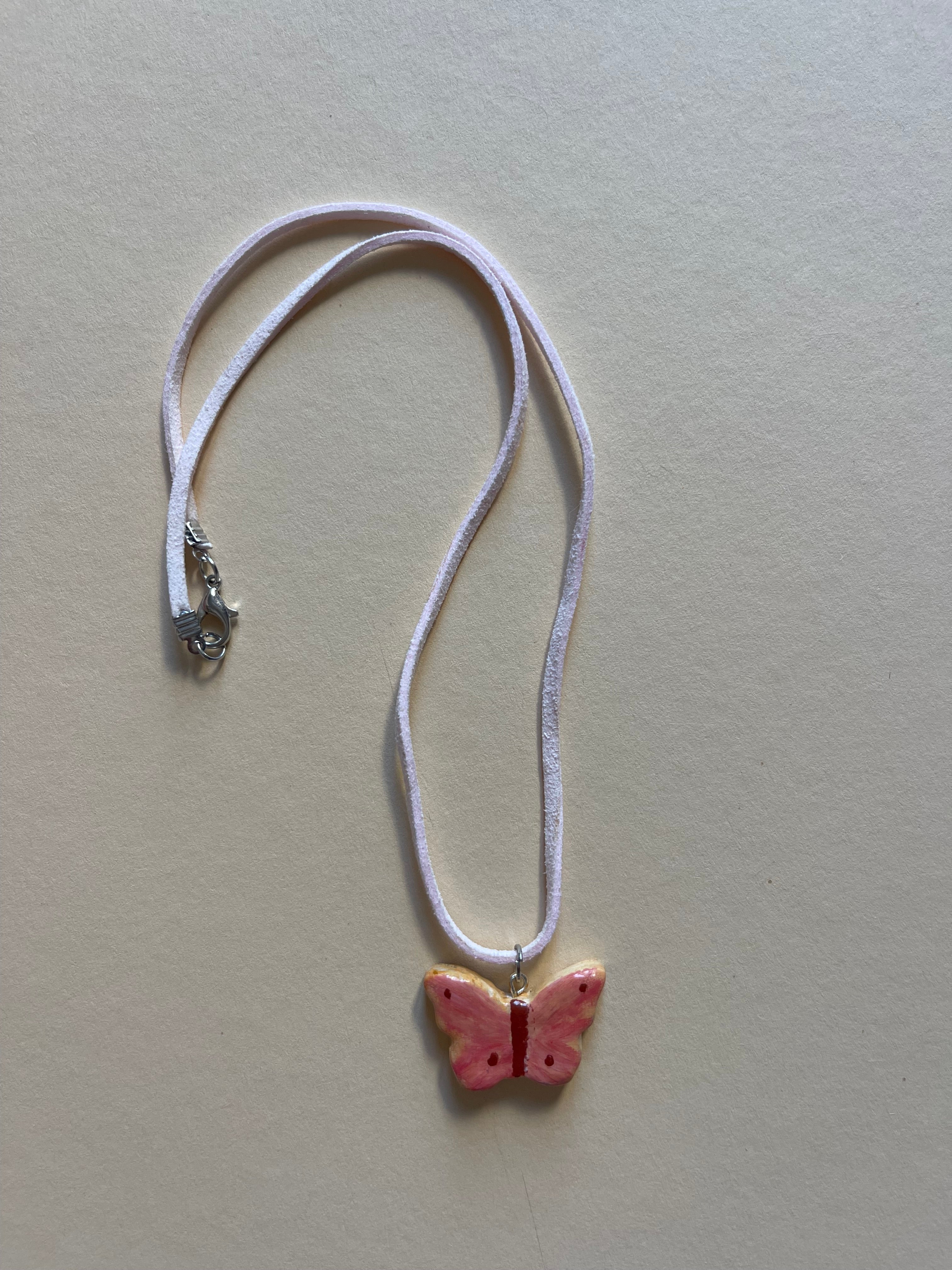 Baby pink butterfly on leather