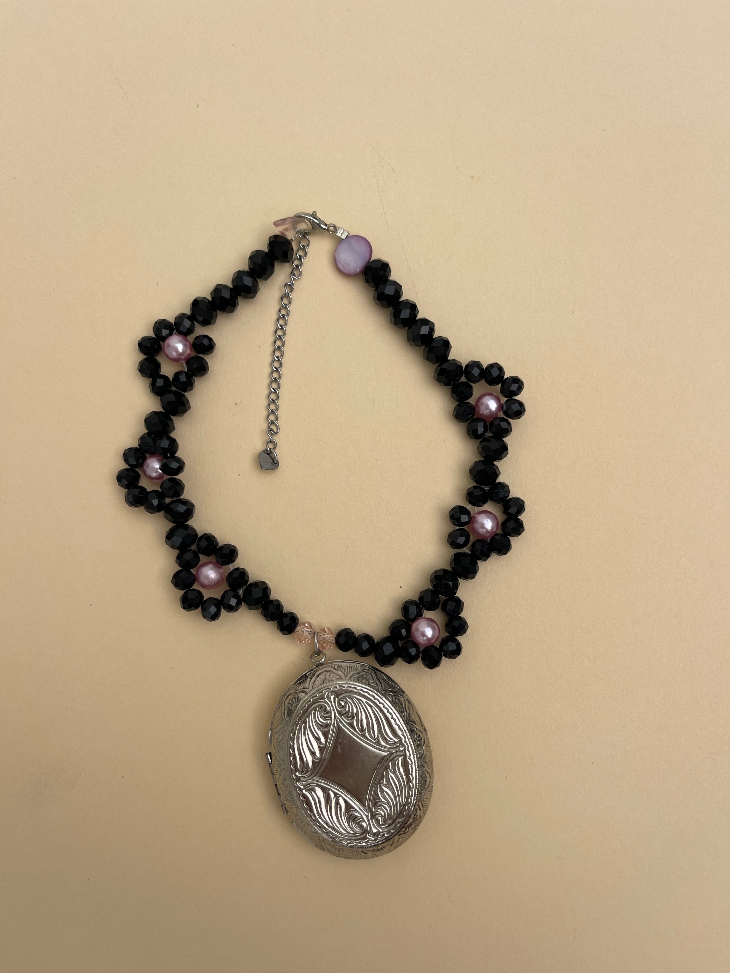 Locket on black daisy chain